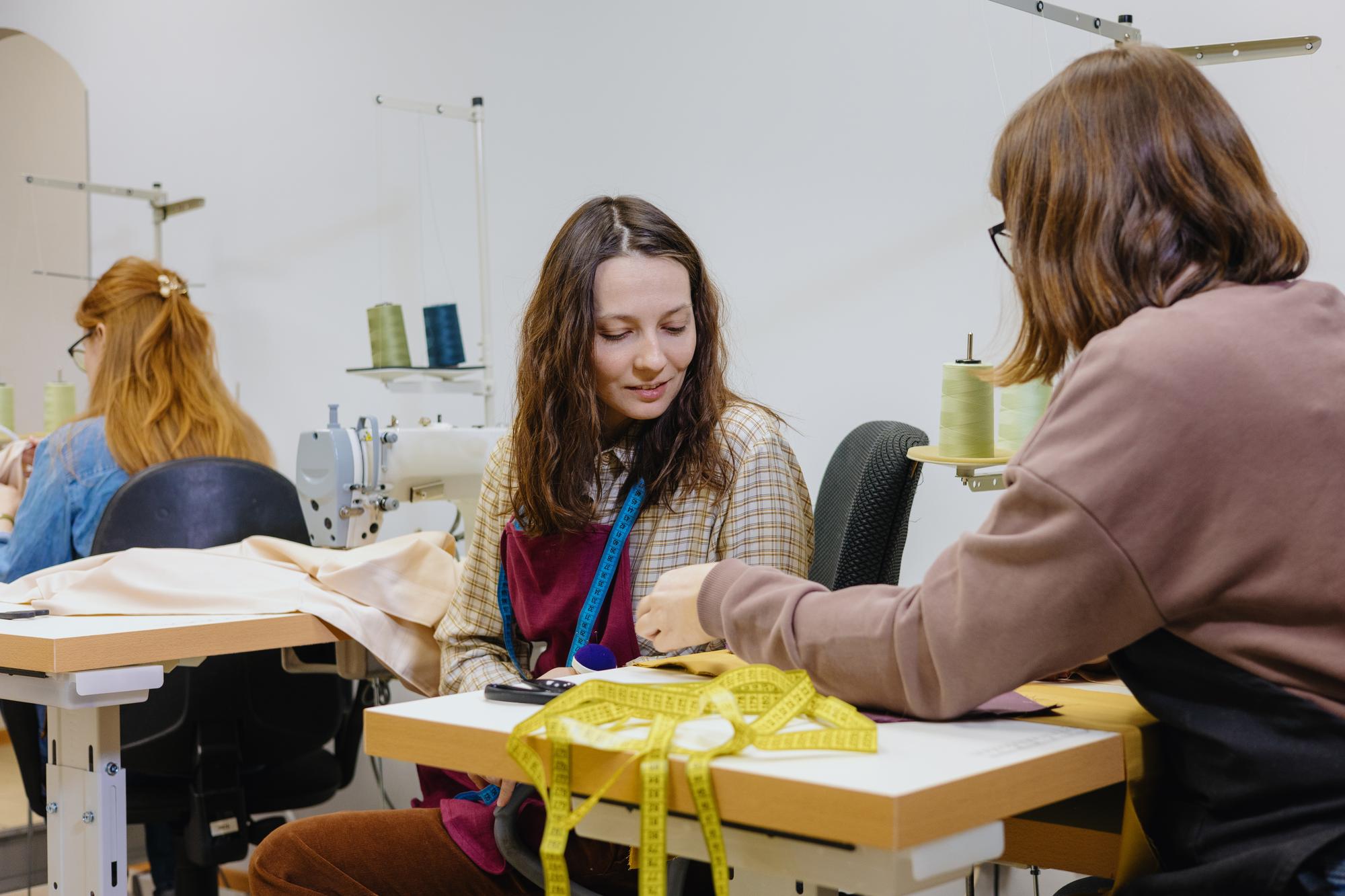workshop teacher demonstrating hand embroidery technique